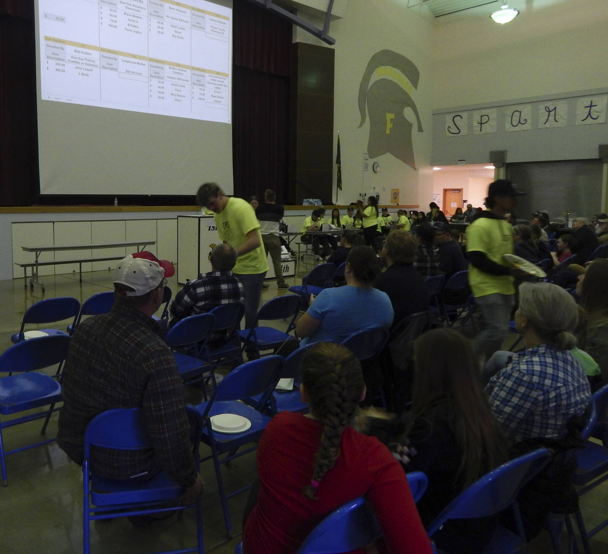 Forks Elementary Principal Matthew Holshouser served as one of the auctioneers for a time on Saturday afternoon …up for bid on the big screen …a fishing trip, cheesecake, a gift basket and a Hoh Tribe paddle.