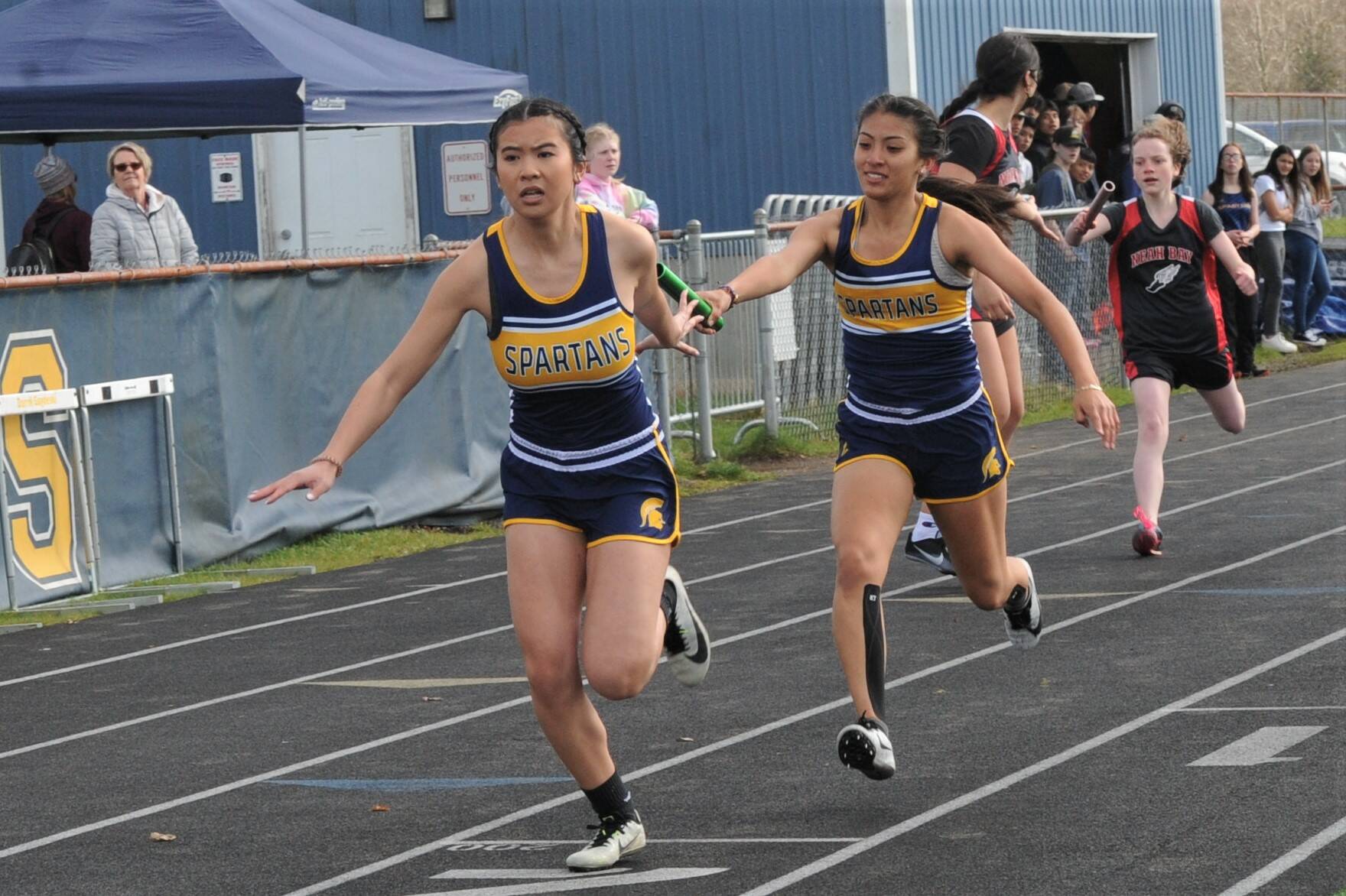 Myra Loung receives the baton from Leslie Beltran in the 4 x 2 relay. Photo by Lonnie Archibald