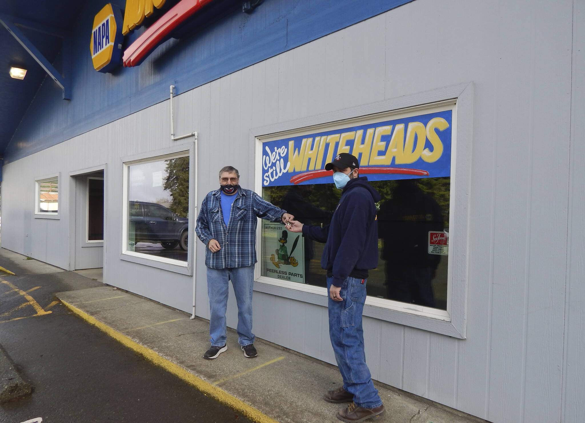 The passing of the torch or more like the keys was recreated by Victor Whitehead and his son Jonathan last Friday as the next generation will take over the operation of the longtime Forks business. Photo Christi Baron