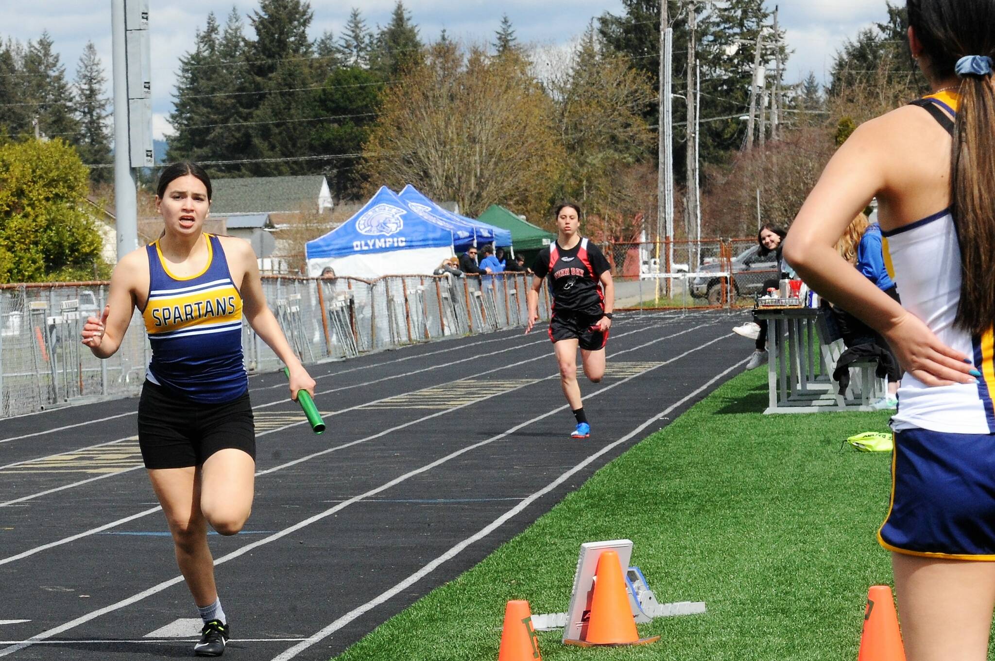Spartan Candida Sandoval reaches the finish line in the 4 X 2 relay. Photo by Lonnie Archibald
