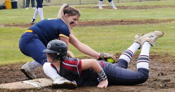 Spartan Kaidence Rigby tags the runner out at first.