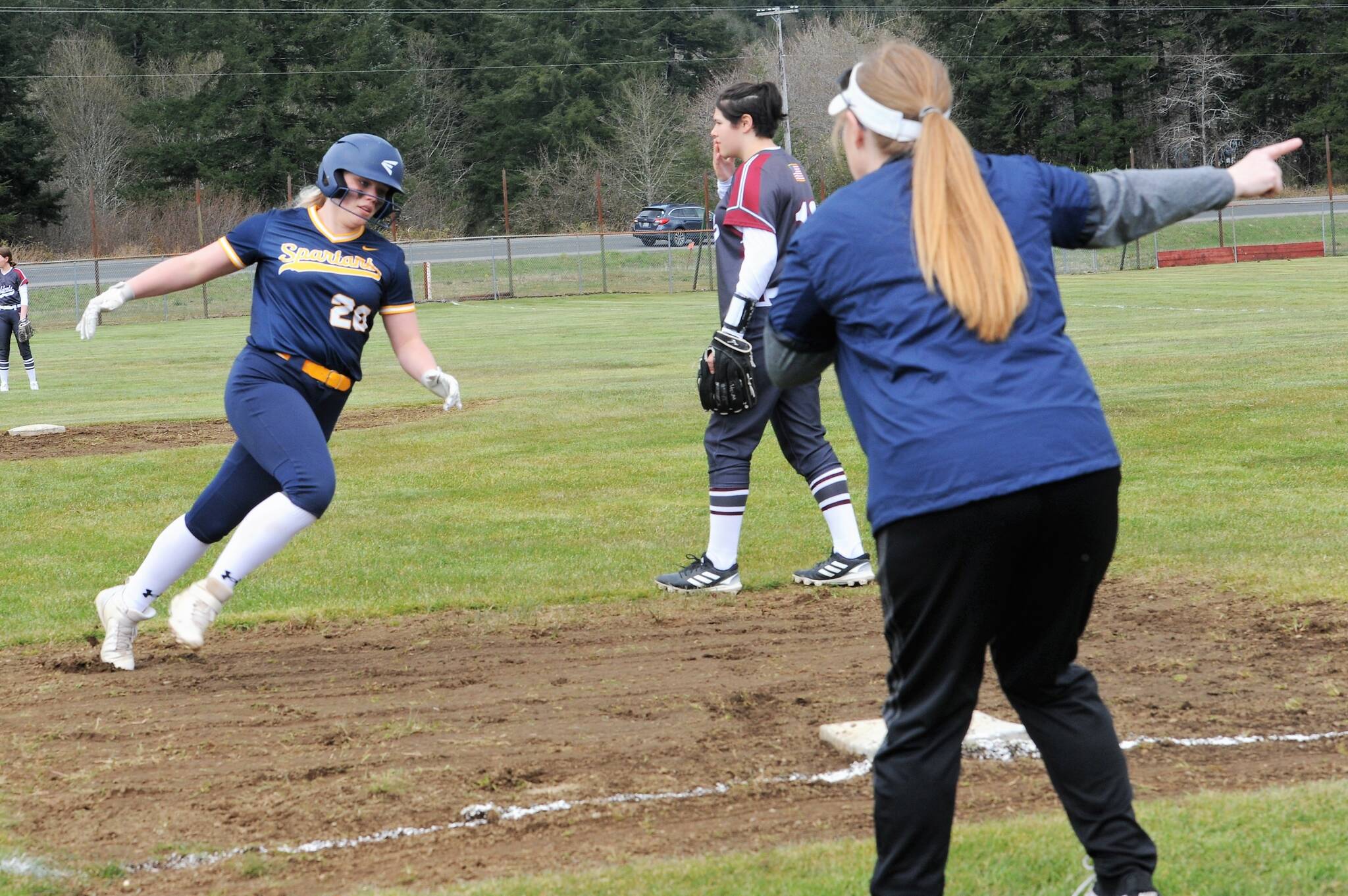 Spartan coach Traci Kratzer waves Kyra Neel around third with a home run.