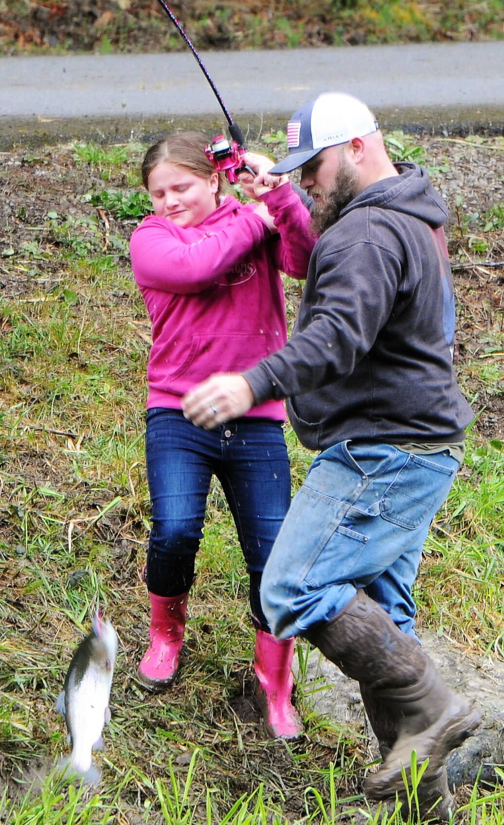 Brynlee Rigby age 8 gets a little help from dad while landing this good-sized trout.