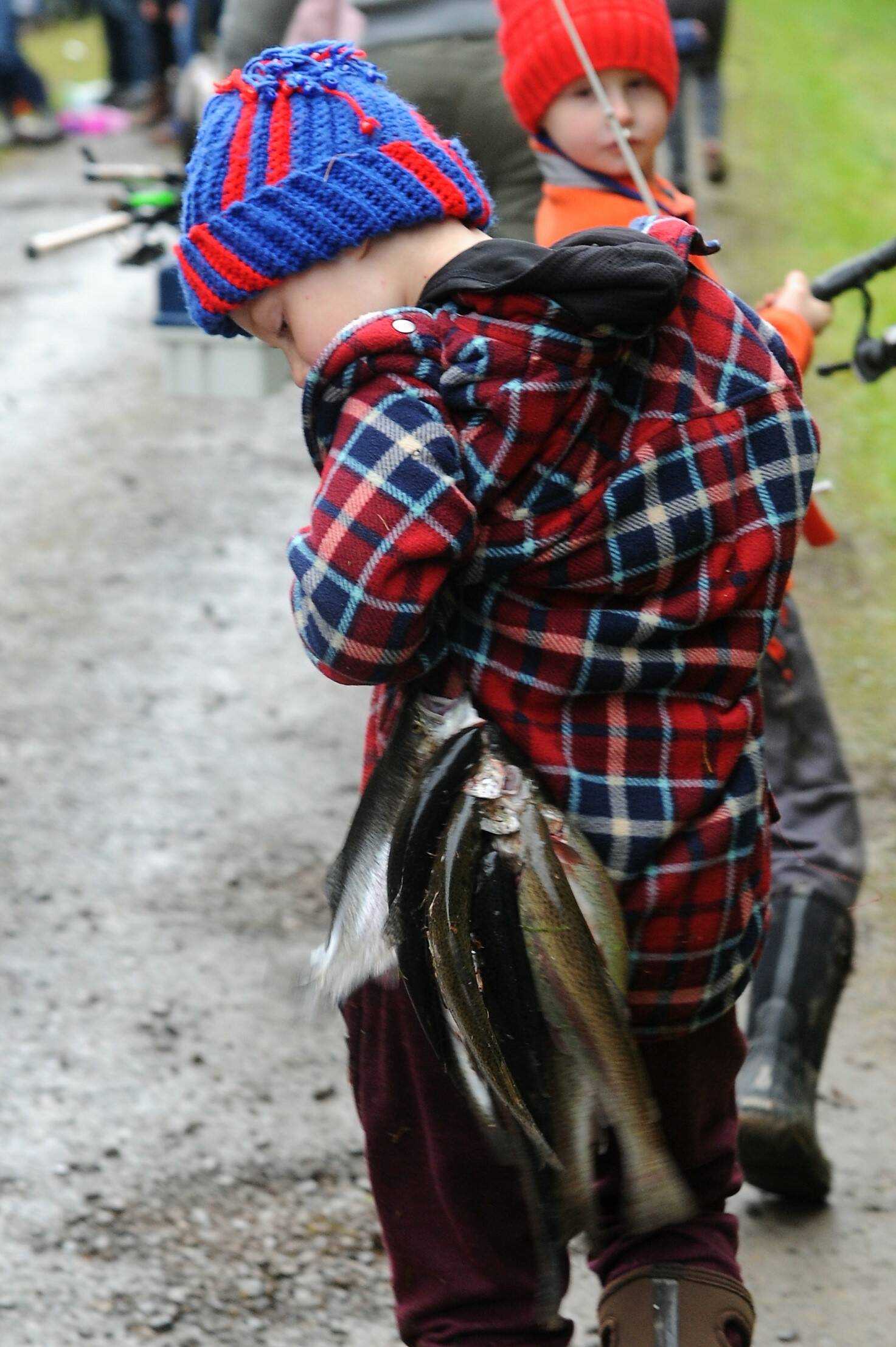 Seven-year-old Wyatt Stonebreaker checks to see if his fish are still hanging over his shoulder as he leaves with his limit.