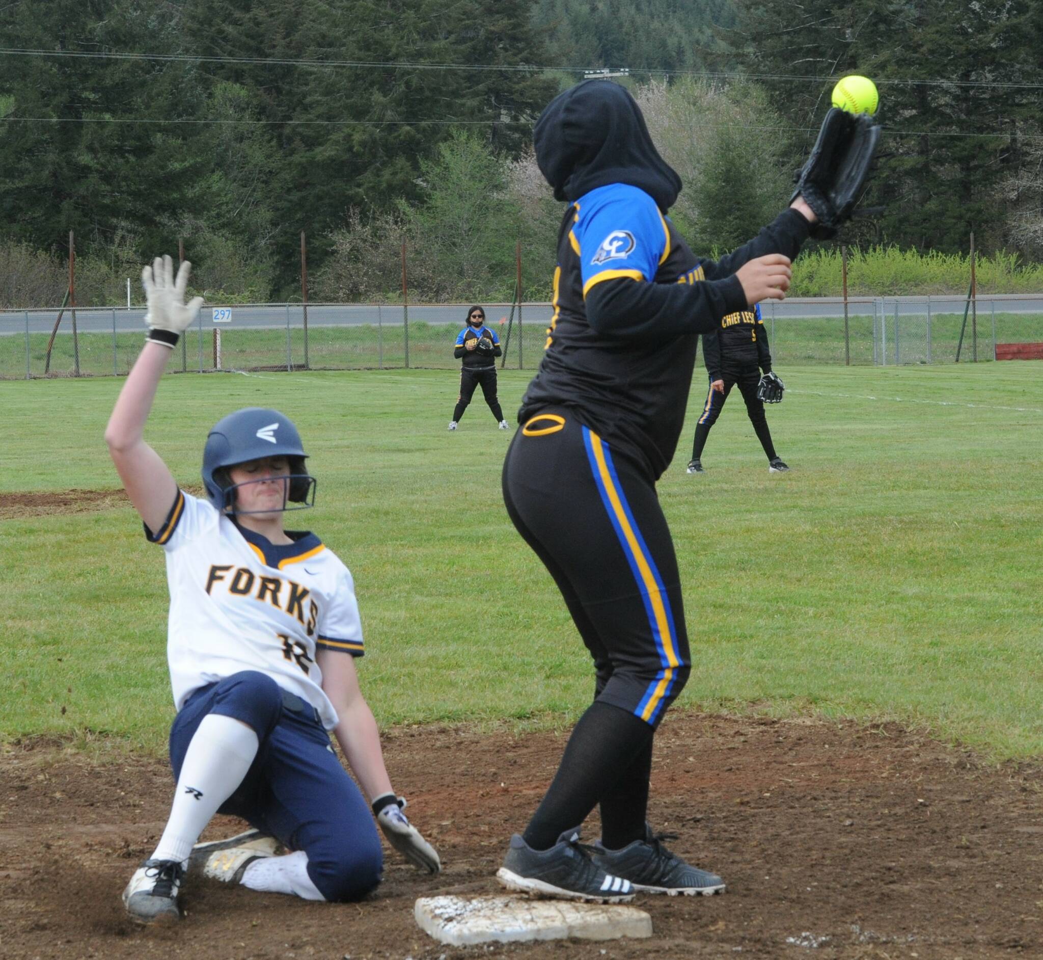 Forks’ Chloe Gayideski-St. John slid safely into third base against Chief Leschi in a doubleheader which turned into a rout in favor of the Spartans.
