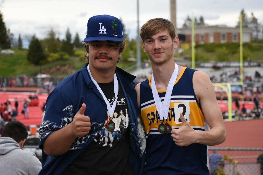 Sloan Tumaua and Ashton Doyle give a thumbs-up and show off their medals.