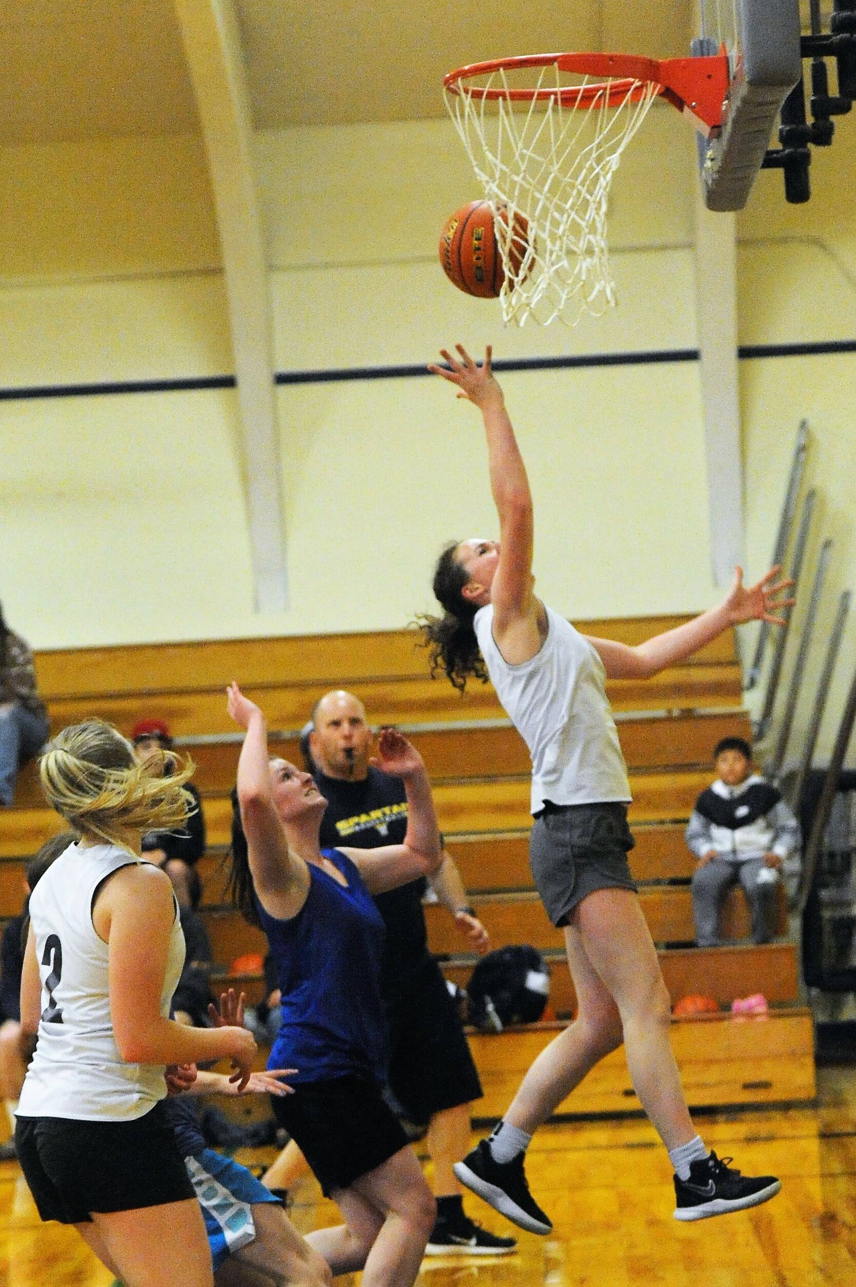 Forks Keira Johnson scores past Crescent defenders.