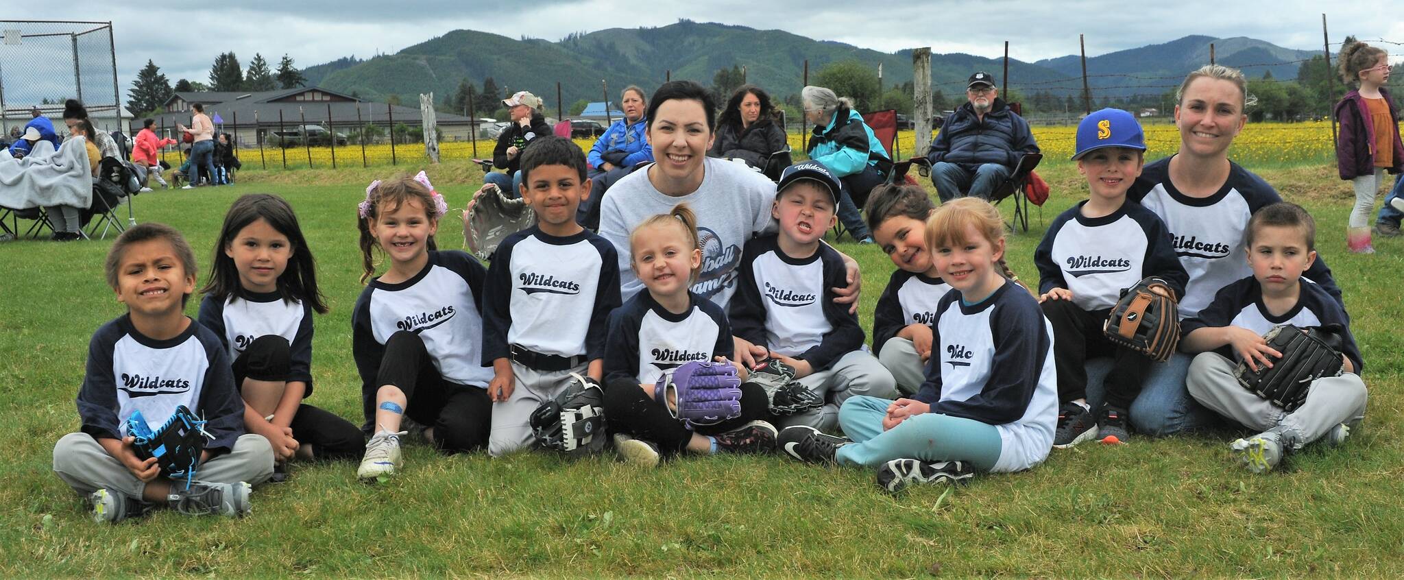 The Wildcats took time to pose for the media after their pre-game meeting here at Duncan Field. In the background parents, grandparents, mothers, fathers, uncles, and aunts along with cousins and siblings await the big game. Photo by Lonnie Archibald