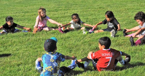 The Black Bears in the 4 to 6 age group were serious about their calisthenics prior to practice. Photo by Lonnie Archibald