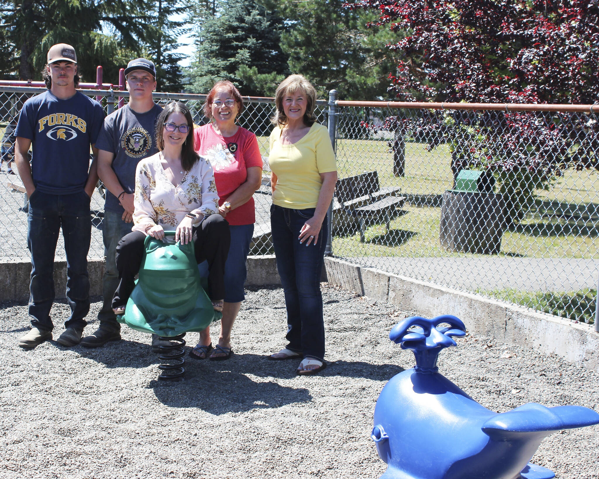 Above, Soroptimist International of the Olympic Rainforest Economic and Social Development Committee members Sarah Hanson (trying out the new frog), Sharla Fraker, and Elena Friesz (standing behind) with City of Forks Public Works employees (summer crew) Landin Davis and Kaleb Blanton. Not pictured are Public Works employees Mike, Brett and Ryan who were going to do the photo but had a concrete truck arrive at the same time! Photo Christi Baron
