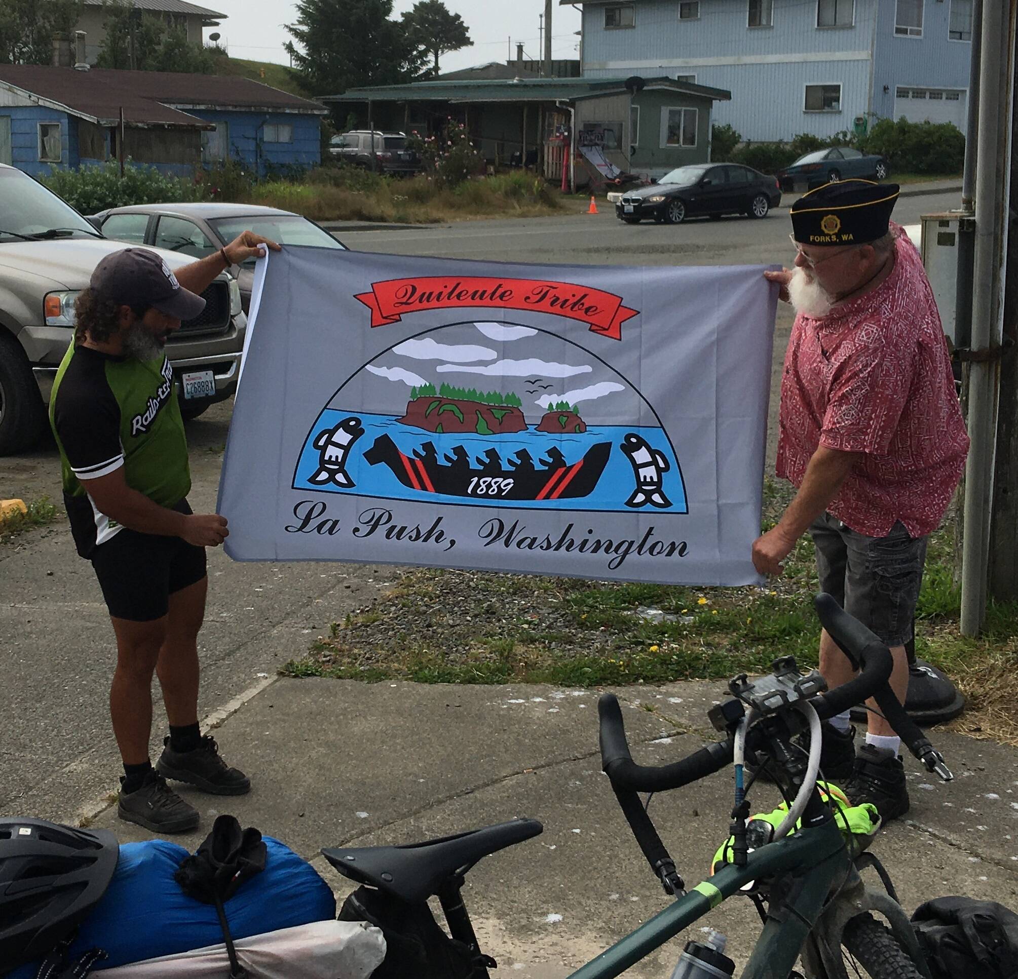Sainato and Forks American legion Post Commander Bubba Bolin with a Quileute flag that was presented to Sainato.