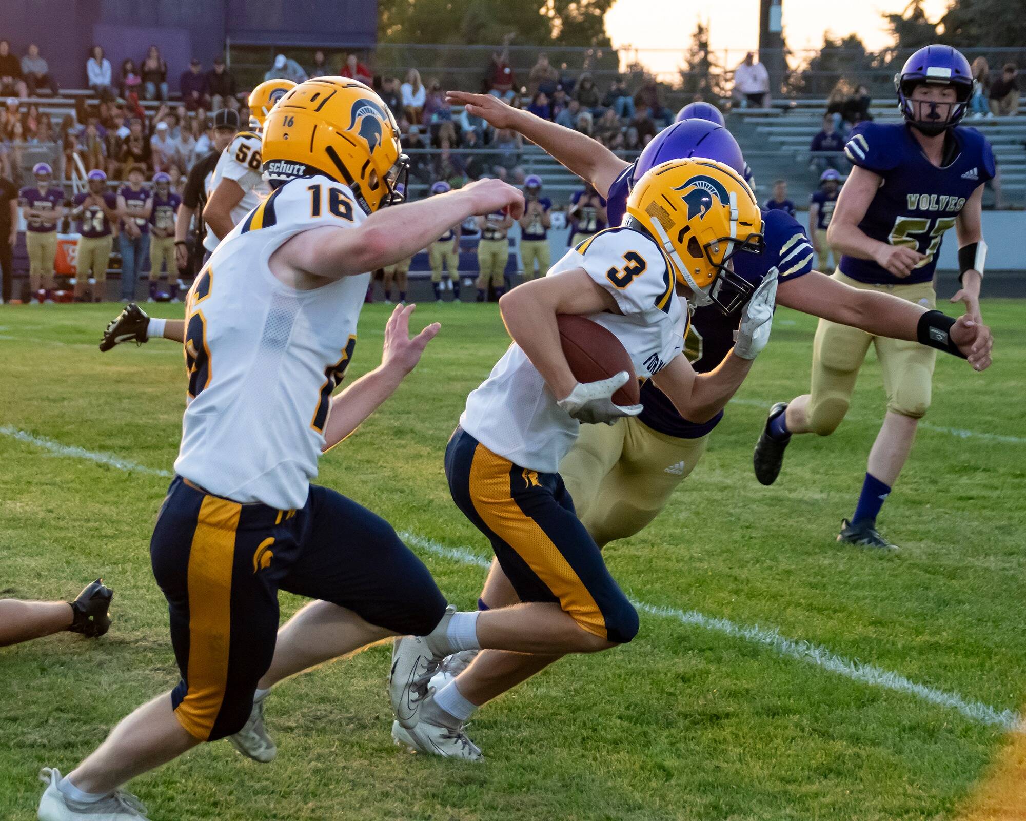 Conner Demorest #3 with the ball and #16 Gunner Rogers and #56 Brody Lausche.