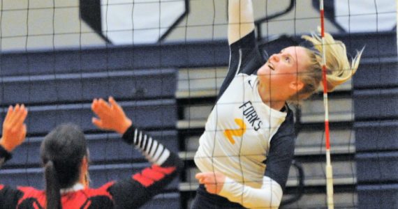 Spartan Kadie Wood (2) goes high above the net for a hit.