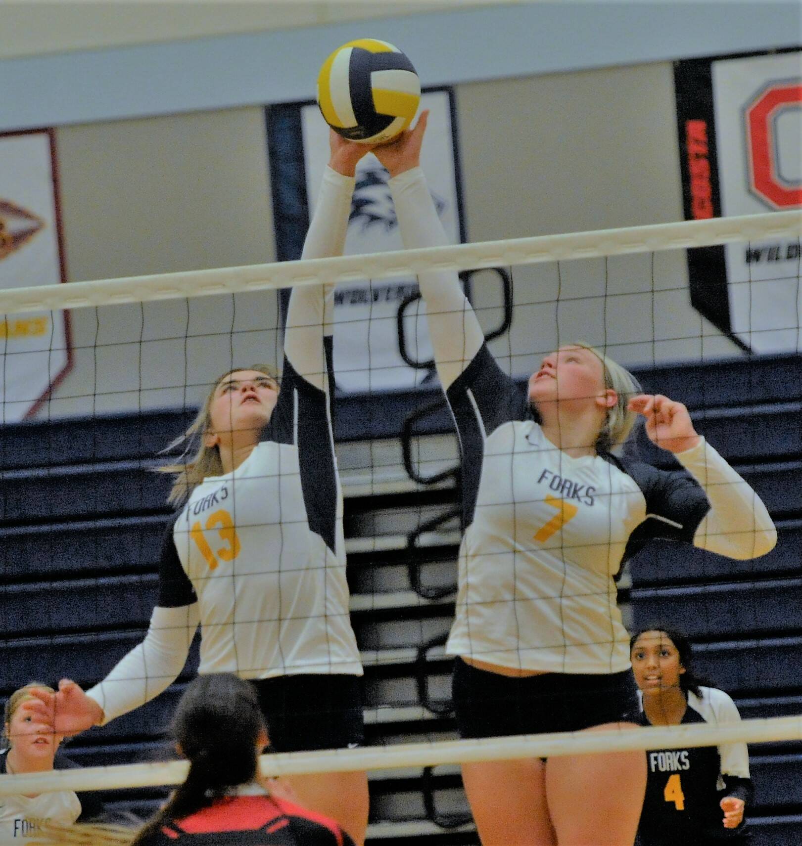 Spartans Kaidence Rigby (13) and Kyra Neel (7) in action while Eladia Hernandez Stansbury (4 ) looks on.