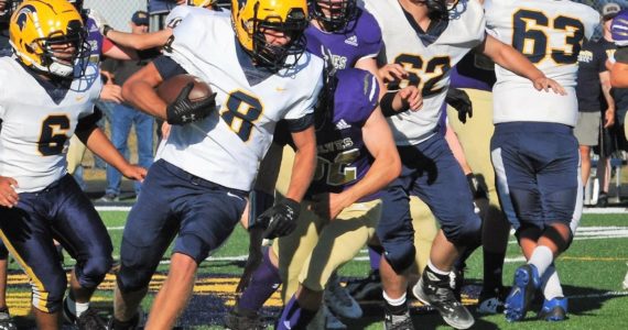 Spartan Camryn Kennedy (8) picks up a first down behind the blocking of Logan Hestand (6), Robert Lohneis (62) and Carter Coberly (63). Photo by Lonnie Archibald