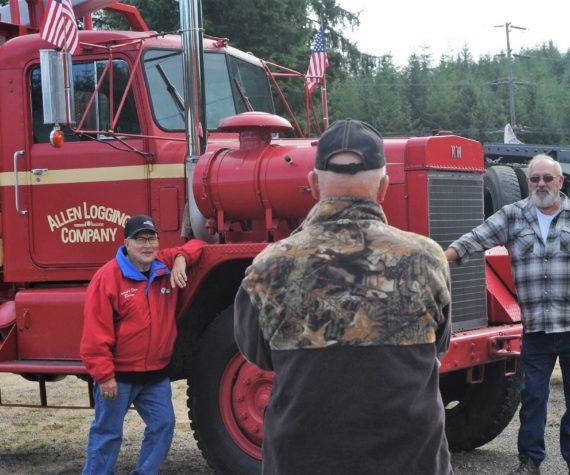 <p>Rene Davis takes time to photograph Don Adams (left) and Howard Goakey in front of the old Allen’s 1966 KW off-highway log truck. Howard drove for Lloyd Allen for a short time but spent many years loading for him while Don told of driving the old truck down the steep logging road from Owl Mountain on the upper Hoh where you didn’t dare lose your air brakes.</p>