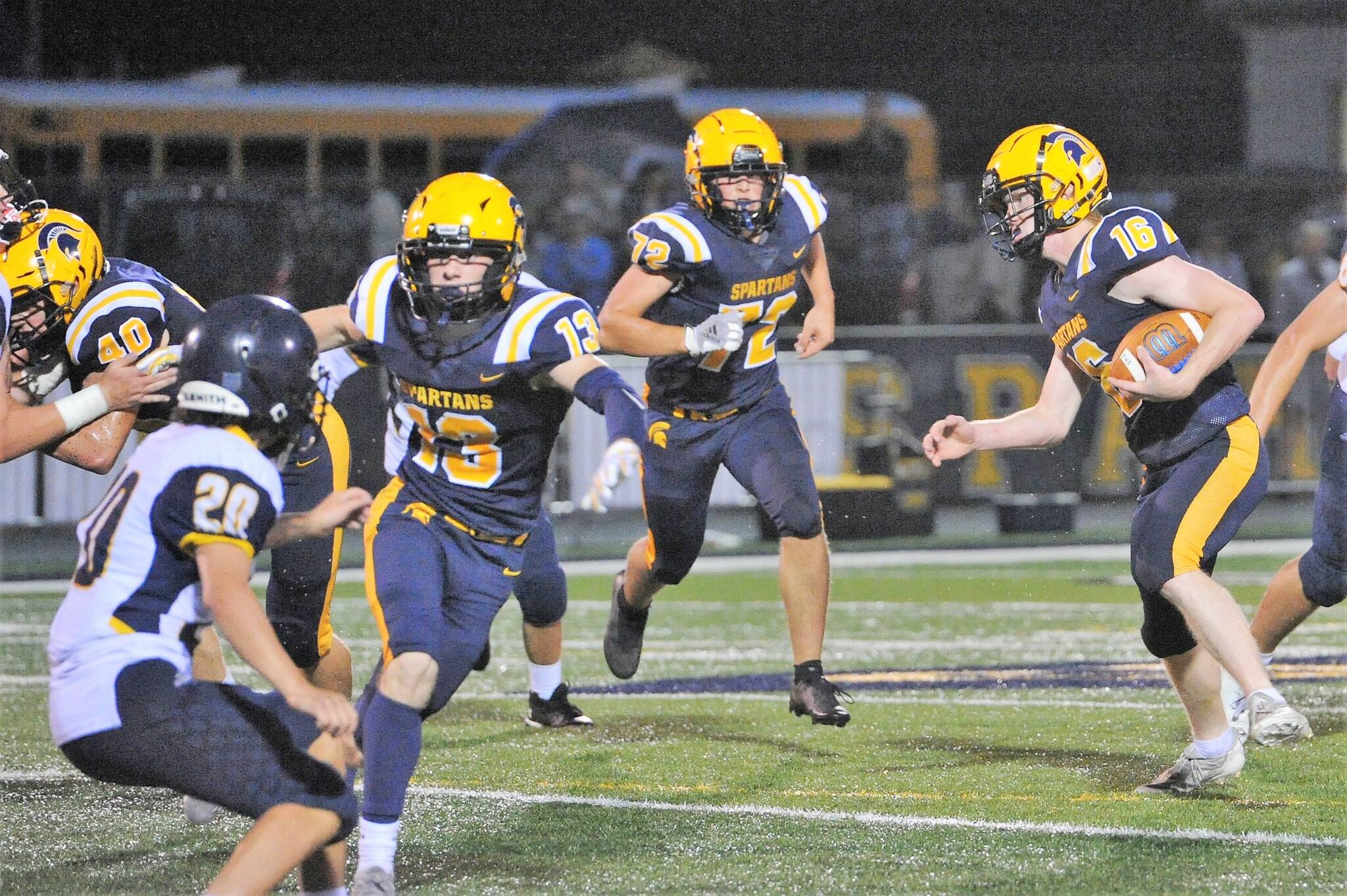 Gunner Rogers runs for a TD behind the blocking of Nate Dahlgren, Ryan Rancourt, and Matthew Wallerstedt. Photo by Lonnie Archibald