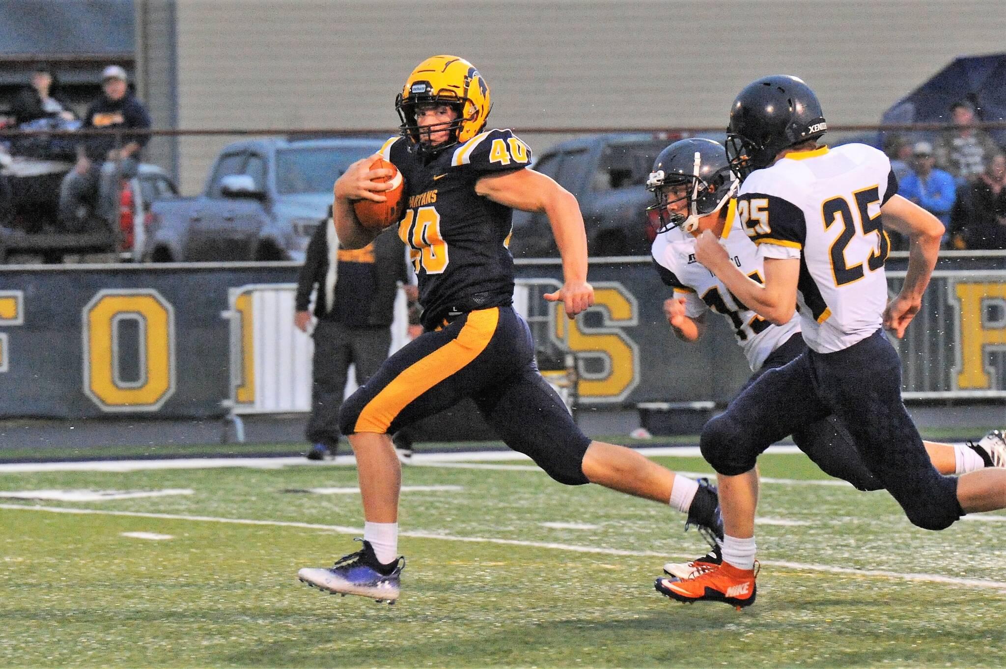 Spartan Nate Dahlgren checks on the last Ilwaco defender en route to a touchdown early in the first quarter against the Fisherman. Photo by Lonnie Archibald