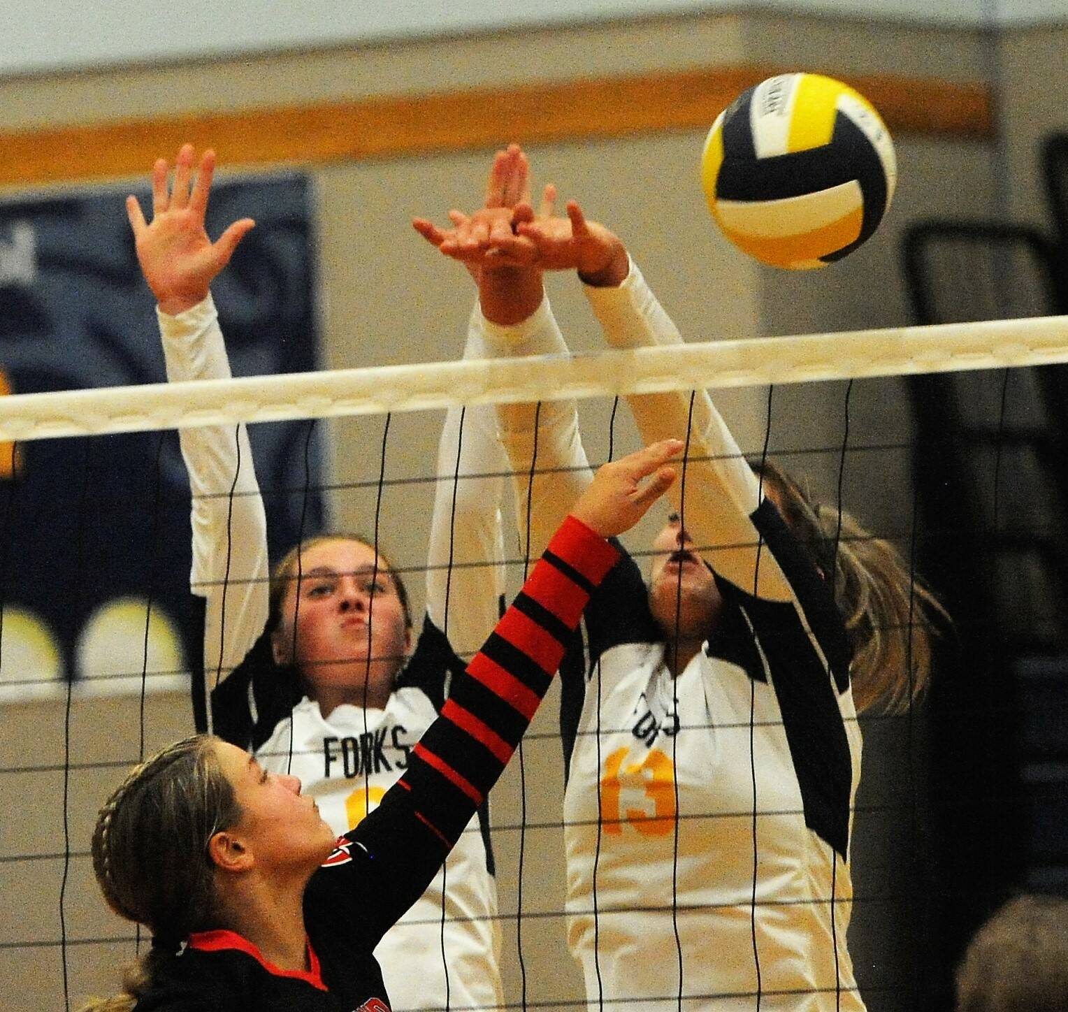 Spartans Chloe Gaydeski-St John (9 left) and Kaidence Rigby battle Raymonds’ Lisa Finne at the net in this contest won by the Seagulls 3 to 2 for the Pacific 2B league lead. Photo by Lonnie Archibald