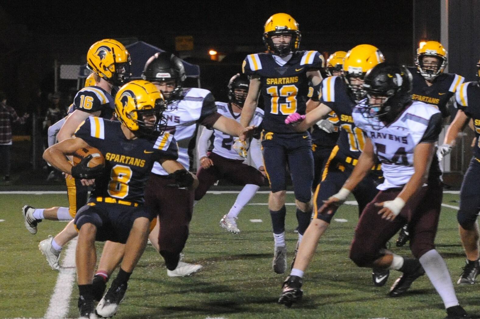 Forks’ Camryn Kennedy (8) looks for running room Friday night in Forks against the Ravens. Also in on the action are Gunner Rogers (16) Ryan Rancourt (13) and Landen Olson (10). Photo by Lonnie Archibald