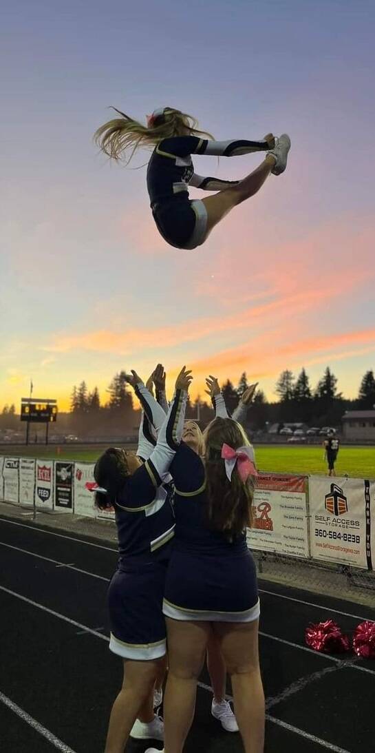 The Spartan Cheer Squad had a lot to celebrate last Friday night with a big win over Rainier. Here Zoie Davis goes high in the sky!