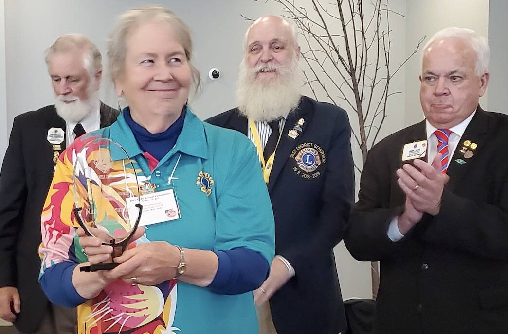 Nancy Messmer holds Distinguished Service Award with Past District Governor John Moralek, District Governor Lyndon Harriman, and Past International Director Alan Hunt. Submitted Photo