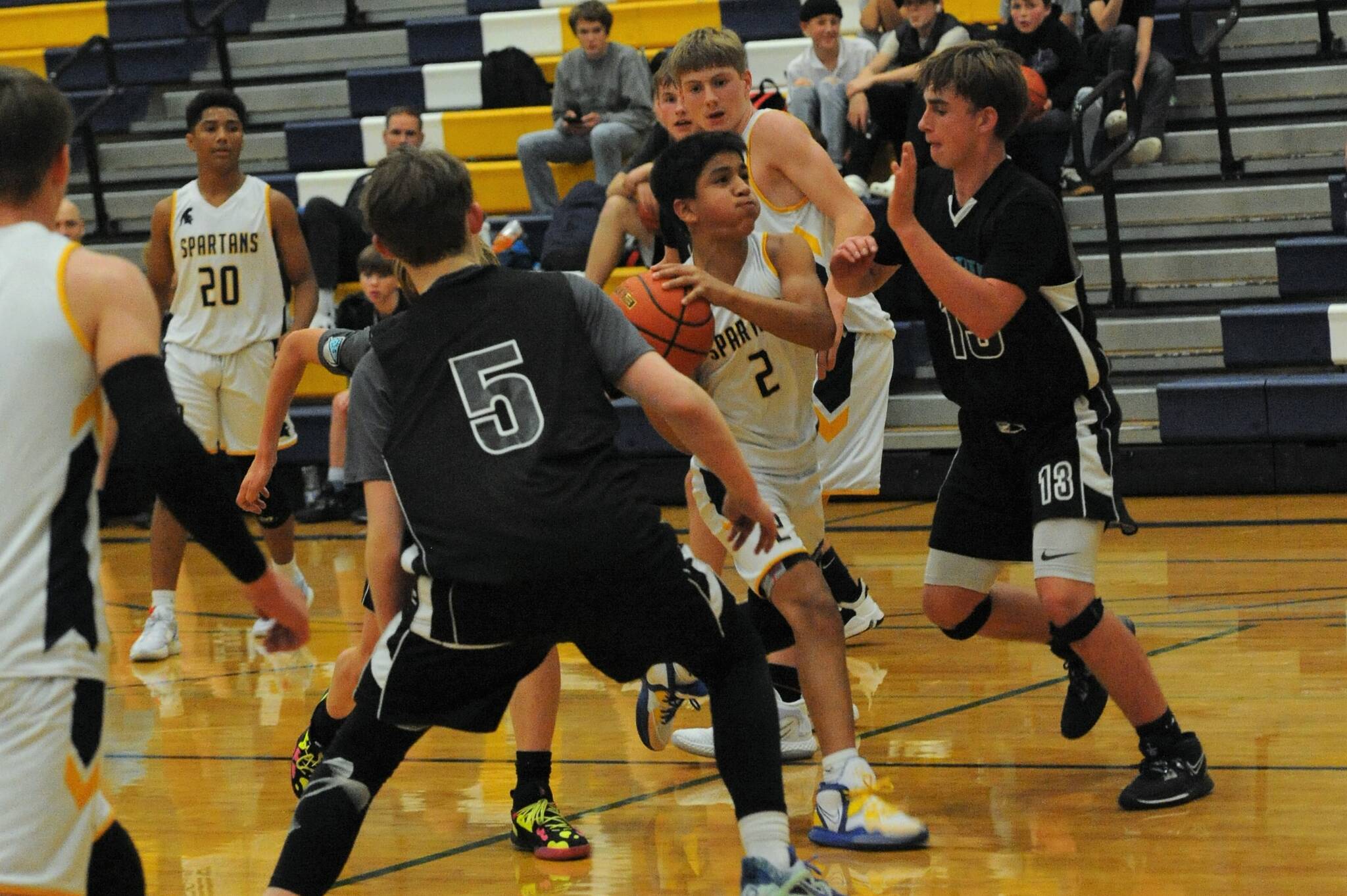 Estevan Ramos (2) drives the key. Also in on the action for Forks are Emanuel Hernandez (20) and Titus Rowley.