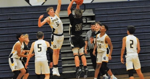 Titus Rowley (30) defends against the Wolves. Also from the left are Spartans Cashtein Barajas, Malachai Rowley, Emanuel Hernandez, and Estevan Ramos.