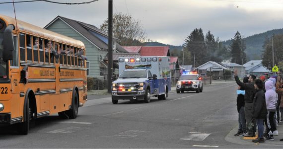 Forks 6th graders were out to support the girls as the Forks High school volleyball team turned down Spartan Avenue en route to Yakima Wednesday, Nov 9. Community well-wishers also lined Forks Avenue providing a great send-off as the Spartans headed to state for the first time in almost 20 years. Photo by Lonnie Archibald