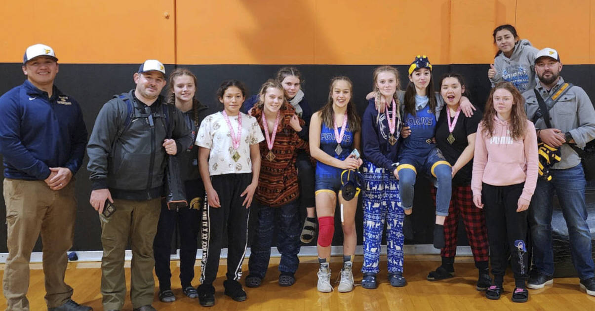 The Forks girl’s wrestling team celebrates its second-place trophy at the Lady Mountaineer Tournament. (Forks wrestling)