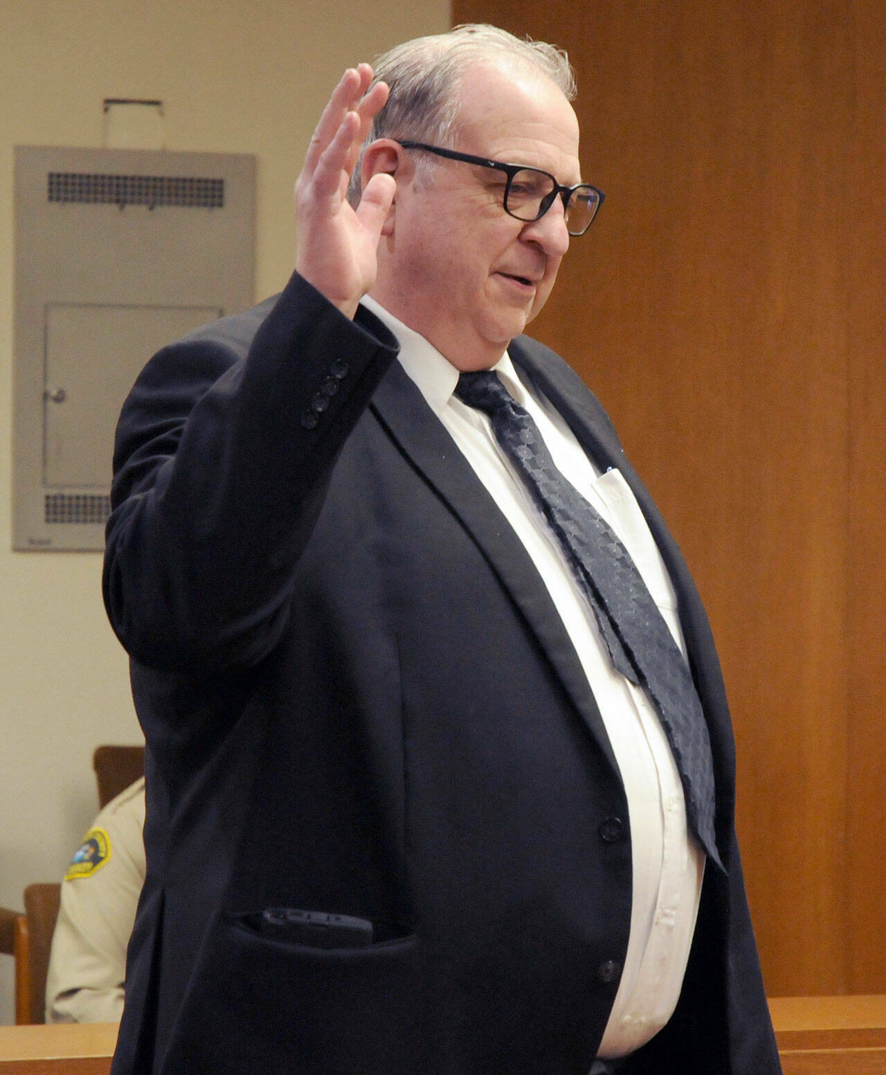 Bruce Hanify takes his oath on Wednesday for his position as District Court 2 Judge. (Keith Thorpe/Peninsula Daily News)