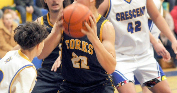 Forks’ Brody Lausch, center, looks for an opening surrounded by, clockwise from left, Terrell Emery of Crescent, LandinDavis of Forks, and Conner Ferro-May and Henry Bourm of Crescent on Wednesday in Joyce. (Keith Thorpe/Peninsula Daily News)