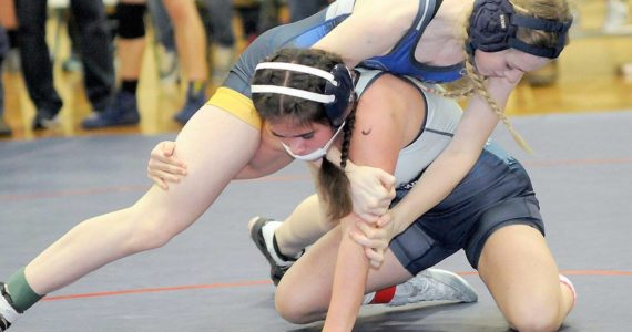 Forks’ Miley Blanton, top, takes on Grace Odun of River Ridge in the 119-pound class on Saturday at Port Angeles High School. (Keith Thorpe/Peninsula Daily News)