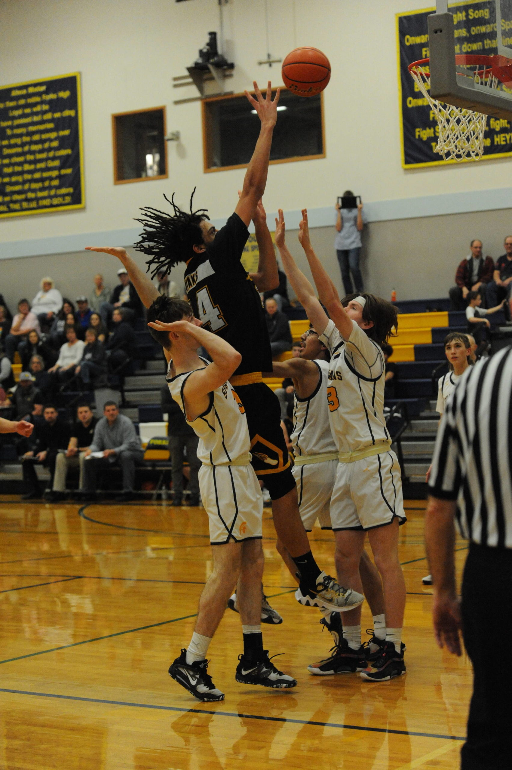 Spartans (from left) Ryan Rancourt, Brandon Galeana and Kaleb Callaghan defend against Hyak Tyrell Hovland in the closing moments of this contest won by Forks over North Beach. Photo by Lonnie Archibald