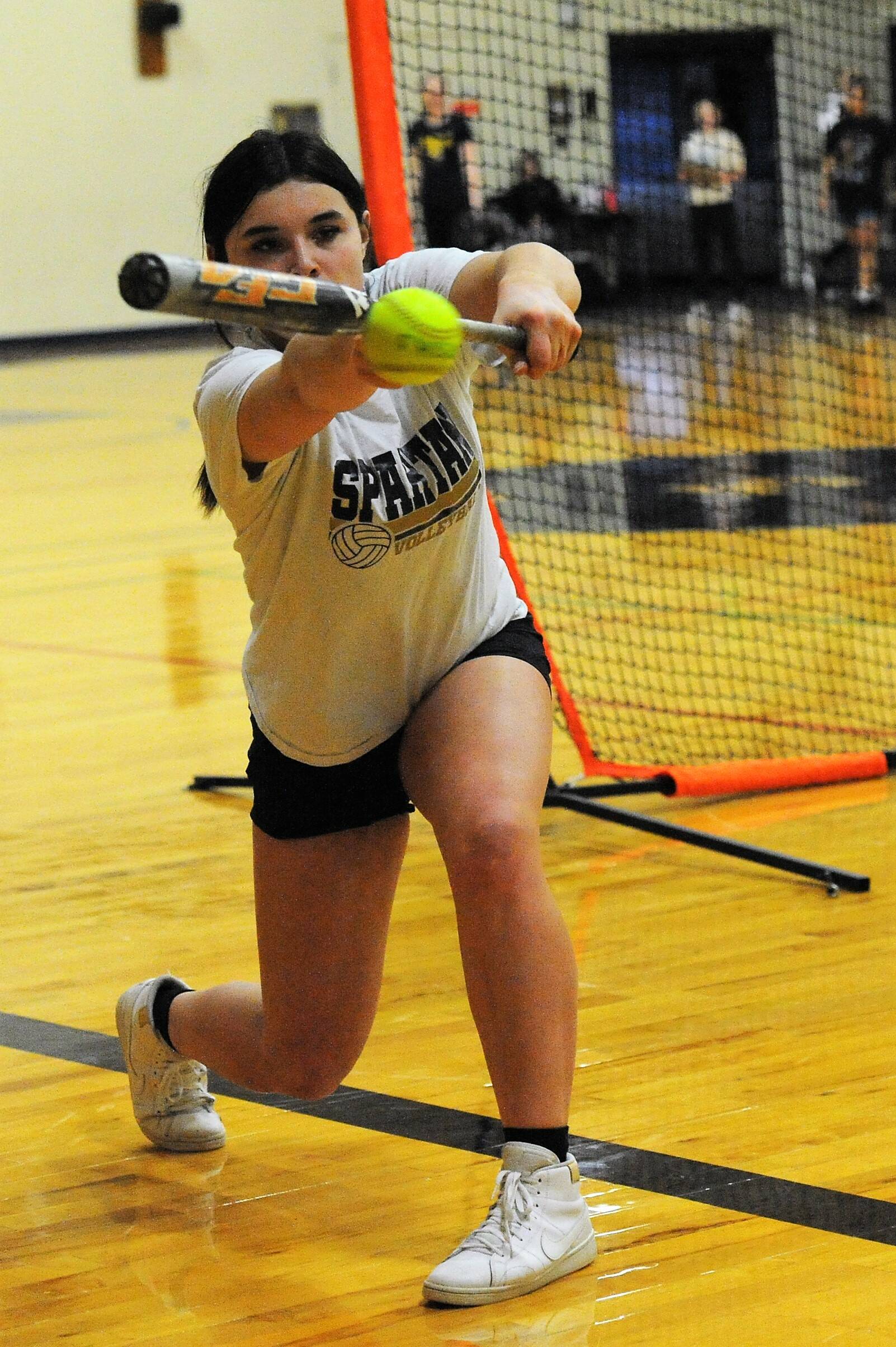 Softball player Kaidence Rigby goes through bunting drills in preparation for the upcoming fastpitch season. Some 21 athletes are participating. Forks finished third in state last season. Photo by Lonnie Archibald