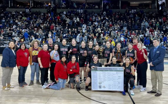 The Neah Bay girls basketball team celebrates winning the 1B state championship Saturday night in Spokane. (Bridget Mayfield/for the Peninsula Daily News)