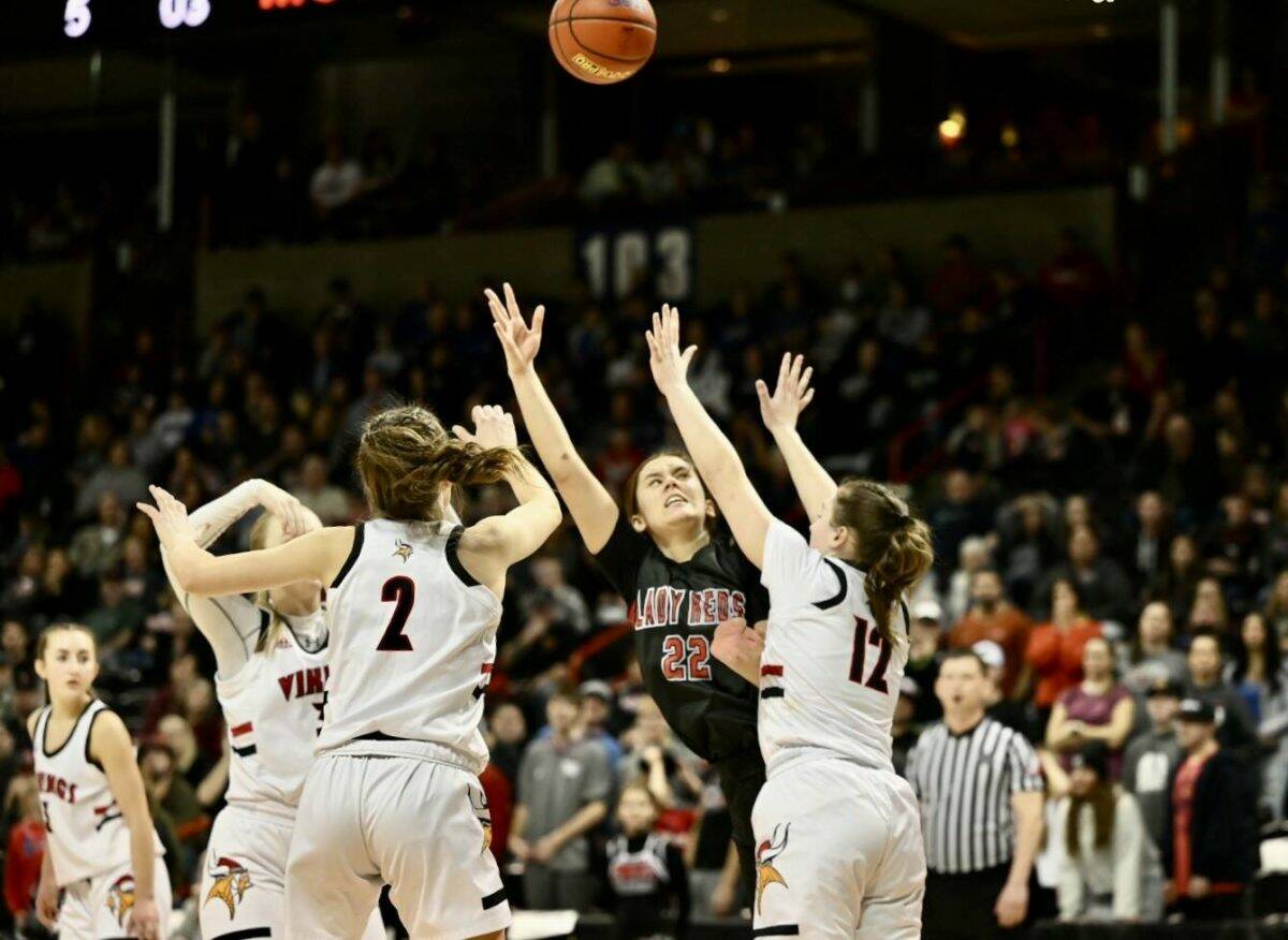 Neah Bay’s Amber Swan battles to get a shot off against Mossrock. Swan finished with 11 points and 11 rebounds in Neah Bay’s 56-54 win. (Bridget Mayfield/for the Peninsula Daily News)