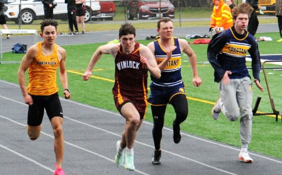 Ryan Anderson and Isaac Gonzales in the 100-yard dash. Photo by Lonnie Archibald