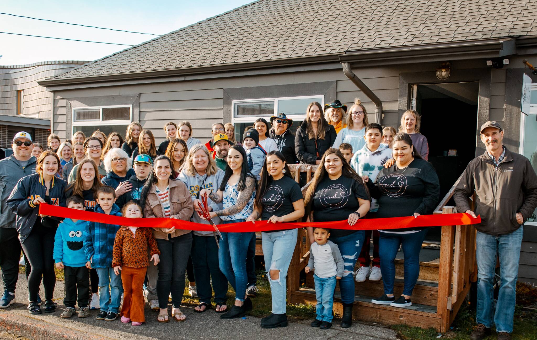 Friends, family, staff, and other Forks business owners recently joined Gwenlyn Gaydeski, in the center with the scissors and Chamber Director Lissy Andros to the left, for a Forks Chamber Ribbon cutting to celebrate the opening of Gwenlyn’s new business, Upper Left Beauty & Wellness Bar. Photo Charlotte Ann Photography