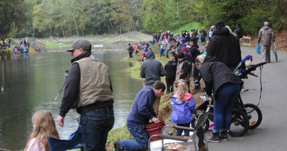 A good-sized crowd of young fishermen along with parents, grandparents, and various family members and friends gave their advice on how to reel in the popular game fish. Photo by Lonnie Archibald