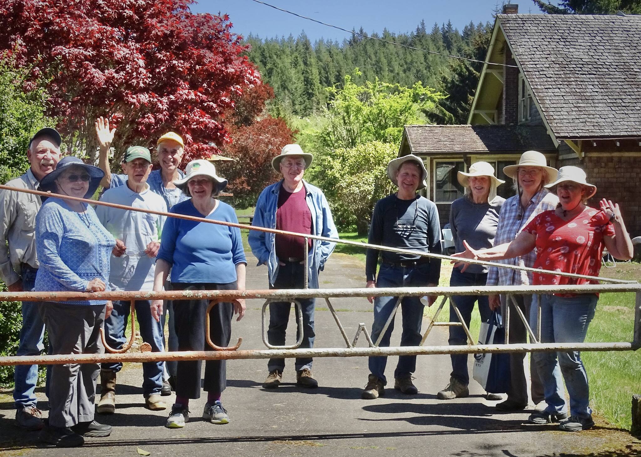 Members of the OOS gather behind the Cowan Farm gate after an afternoon of work. Submitted photos