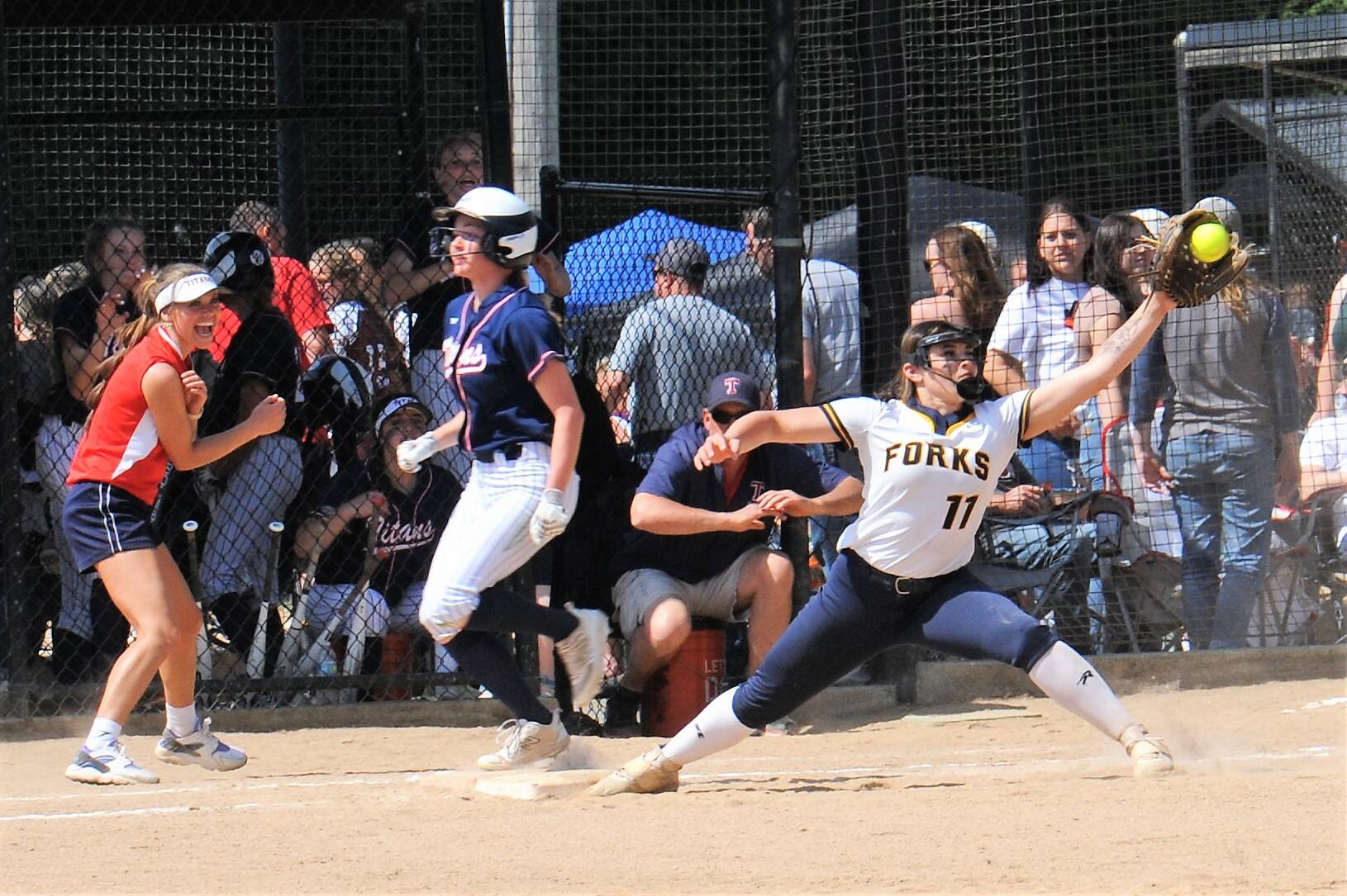 Spartan Kaidence Rigby reaches for the throw to first in a close play called safe by the base umpire.