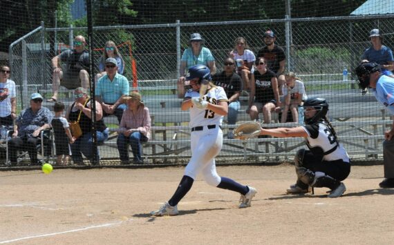Forks’ Kendsie Thompson hits against Rainier.