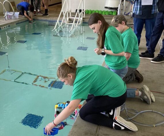 <p>“Forks Whales” team conducts an ROV challenge in the pool.</p>
                                <p>Forks Whales team conducts an ROV challenge in the pool.</p>