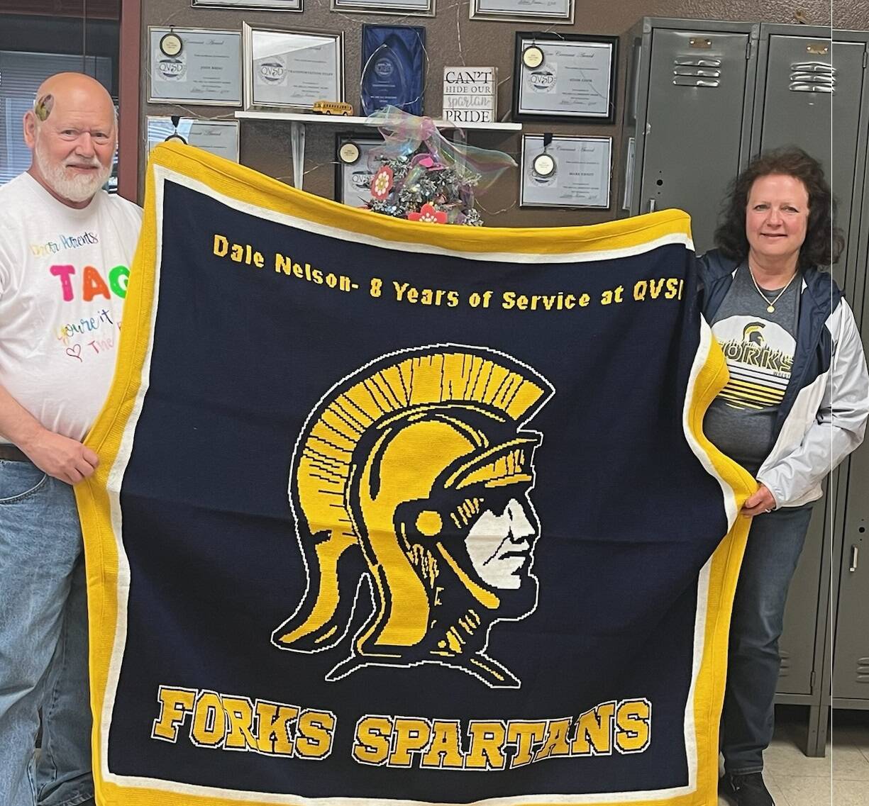 At right, Dale Nelson (QVSD Bus Driver) is presented with a Spartan blanket by Superintendent Diana Reaume after his last bus run to the Hoh River Reservation.