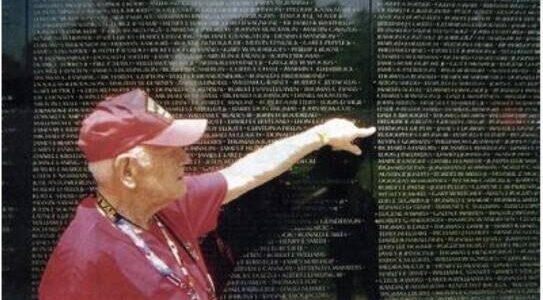 Robert Hall points out Vernon Depew’s name on the Vietnam Memorial Wall.