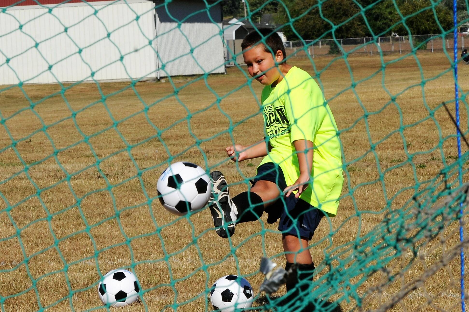 Danniel Price, age 8, with a kick into the net.