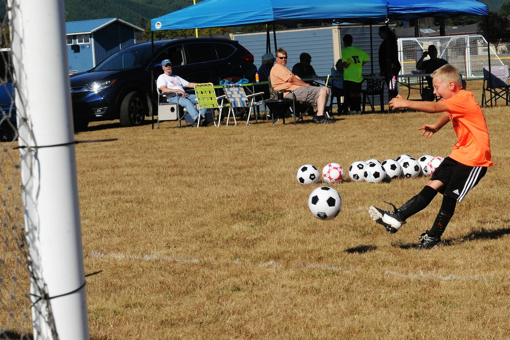 Drew Johnsen, age 8, tries his luck kicking goals.