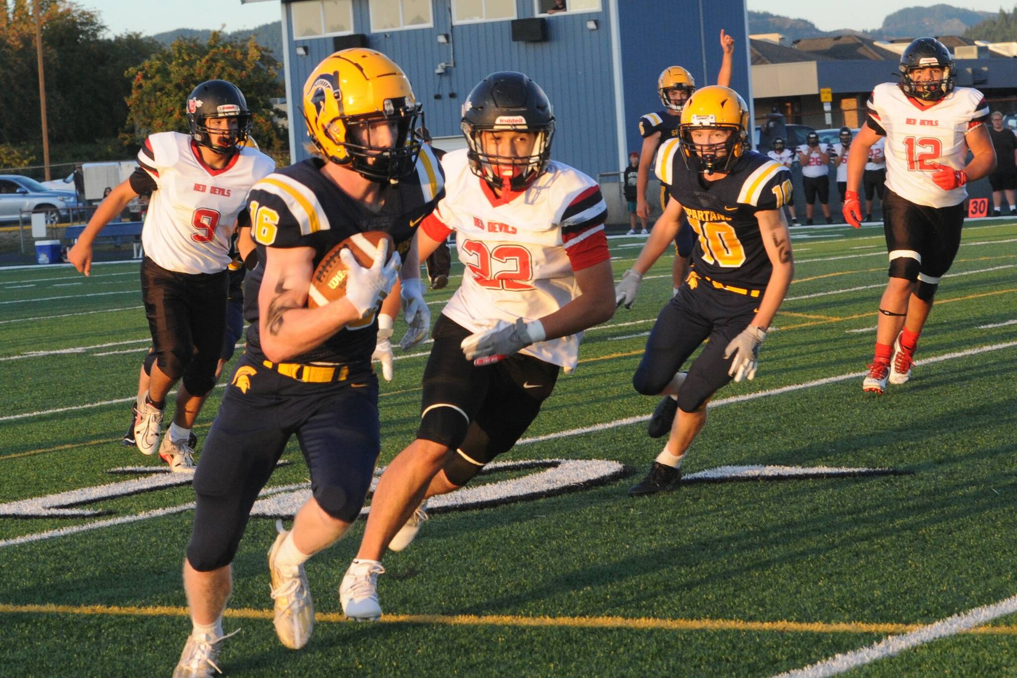 Forks’ Gunner Rogers in route to a TD. Also In the action are Spartan Landen Olson (10) Red Devils Josh Greene (9), Seactis Woodruff (32), and CJ Halttunen (12). Photo by Lonnie Archibald