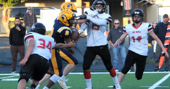 It didn’t take long for the Spartans to get on the scoreboard Friday night in Forks as Spartan freshman Bubba Hernandez took the kickoff 65 yards for the TD. Forks defeated Neah Bay 49 to 16. In on the action for the Red Devils are Tyler Swan (34), Zakius Johnson (15) and Cayden Smith (14). Photo by Lonnie Archibald
